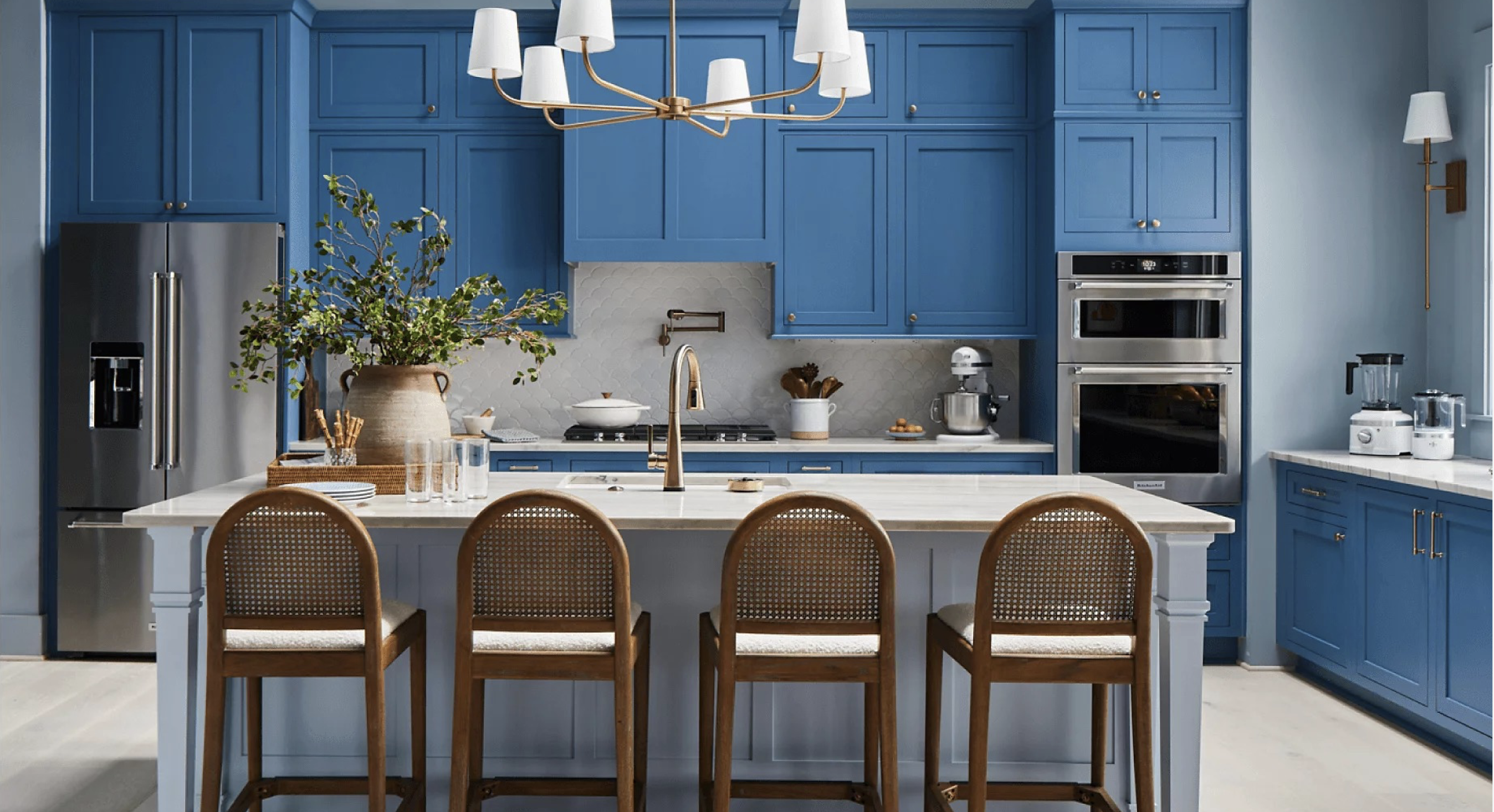 a kitchen with a large island and cerulean blue cabinets featuring KitchenAid appliances